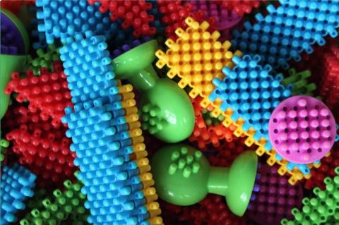 A pile of multi-colored sensory toys with different textures.