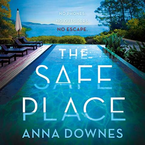 Book cover for "The Safe Place" by Anna Downes. The design shows an infinity pool overlooking a scenic coastal view with trees and mountains in the background. Lounge chairs and umbrellas sit on a wooden deck beside the pool. Text above the pool reads: “NO PHONES. NO OUTSIDERS. NO ESCAPE.” The title “THE SAFE PLACE” is displayed prominently over the pool water, with the author’s name “ANNA DOWNES” below.
