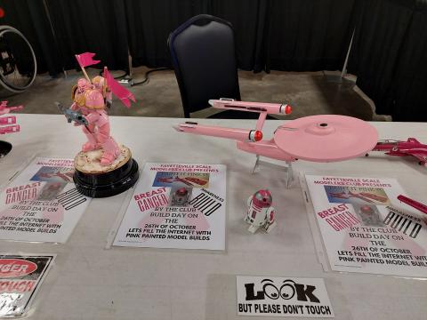 Scale models of a Gundam, R2D2 and the Enterprise TOS painted pink.