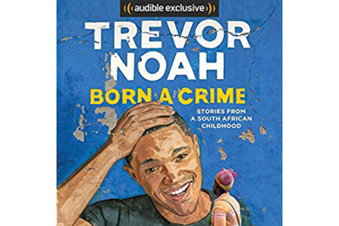 Book cover with a blue, weathered background. Large white text reads “Trevor Noah,” and yellow text below reads “Born a Crime: Stories from a South African Childhood.” The cover shows an illustrated man smiling and touching his head with one hand while holding a small pink flower in the other.