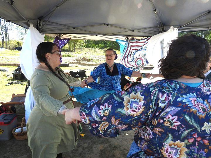 three ladies as part of a ring dance