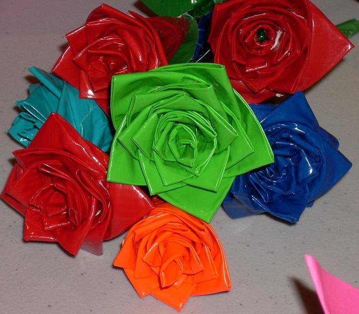 A bouquet of roses made from red, orange, green, light blue and blue duct tape.