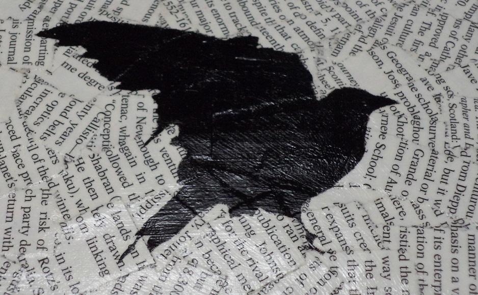 Image of a bird silhouette painted black on a collage of overlapping book text.