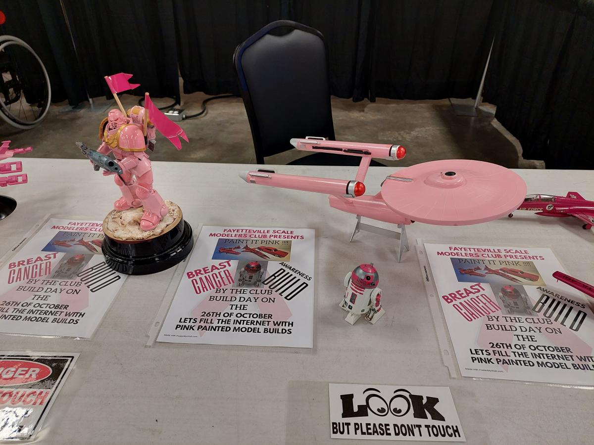 Scale models of a Gundam, R2D2 and the Enterprise TOS painted pink.